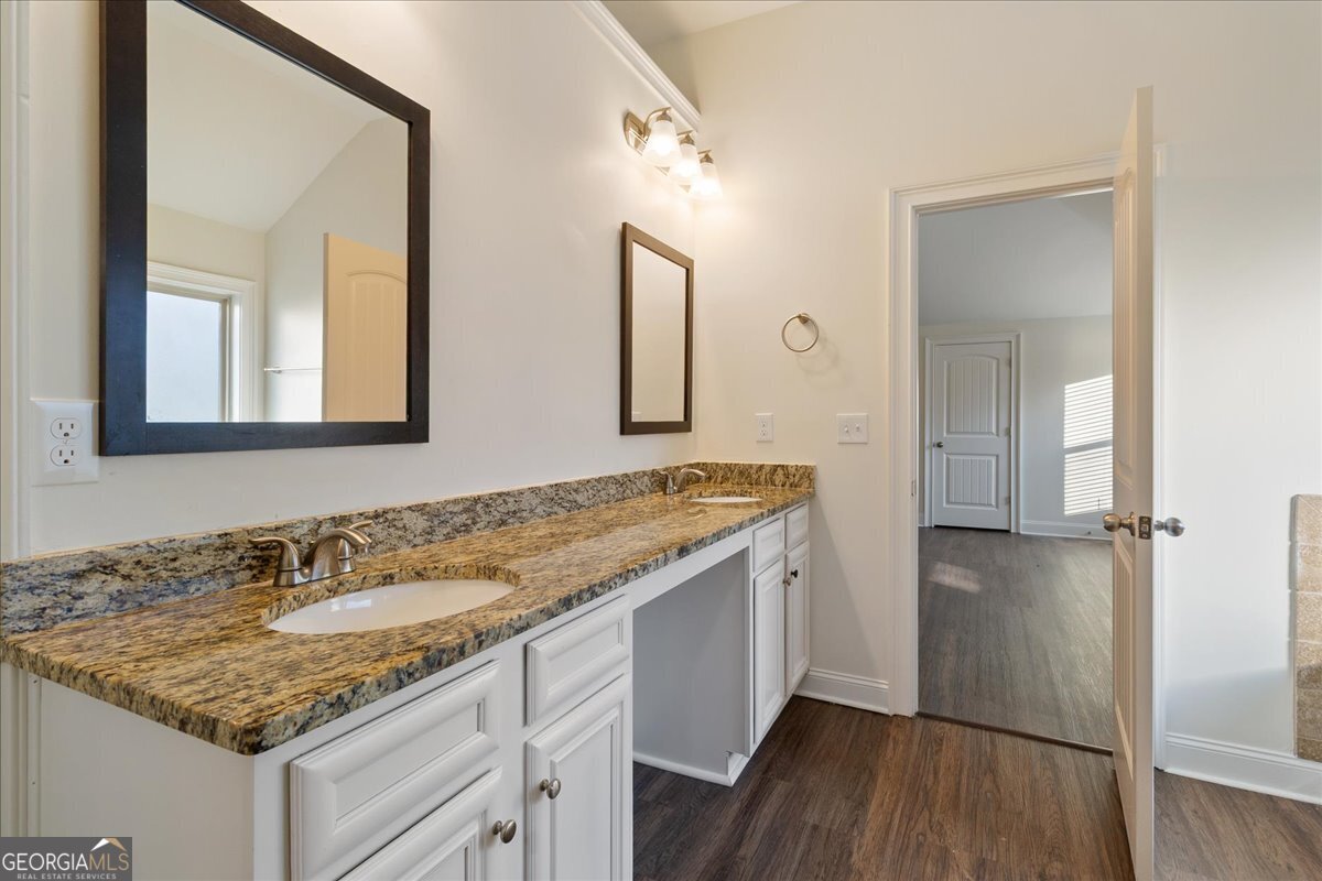 149 Mariahs Walk Hampton, GA 30228 - Photo 31 of 45 a bathroom with a granite countertop sink and a mirror