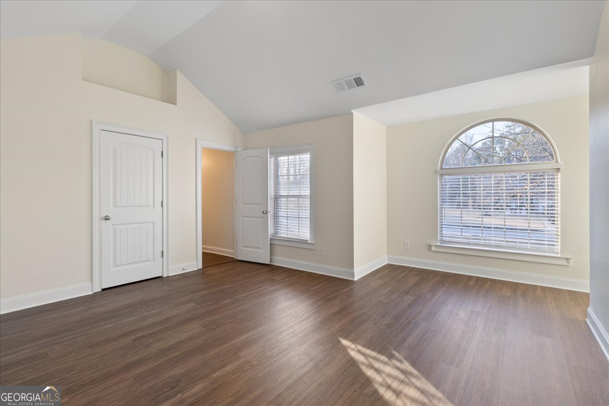 149 Mariahs Walk Hampton, GA 30228 - Photo 33 of 45 an empty room with wooden floor chandelier and windows