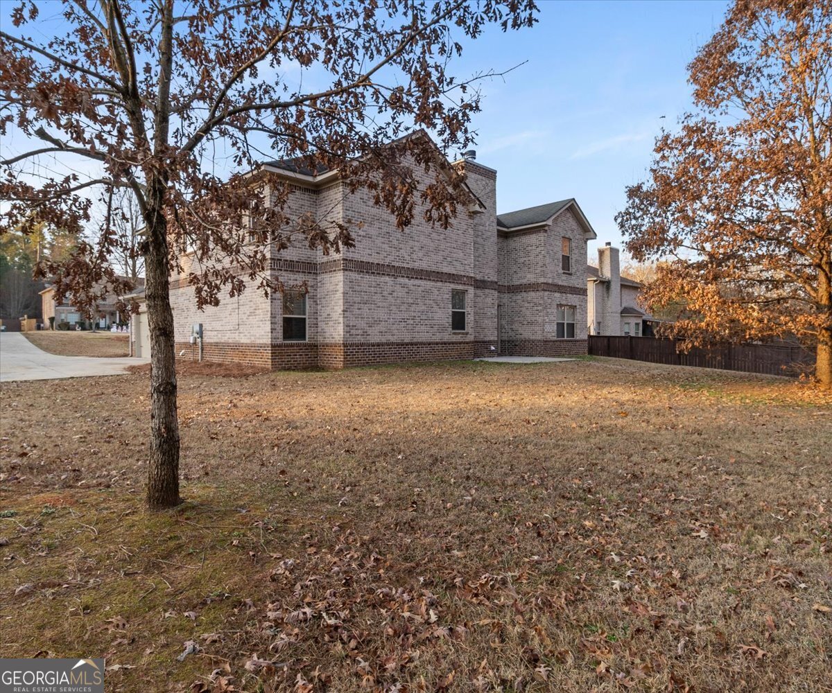 149 Mariahs Walk Hampton, GA 30228 - Photo 40 of 45 a view of a large house with a big yard and large tree