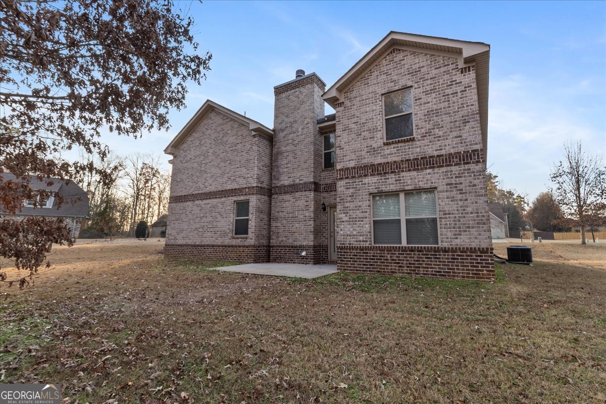 149 Mariahs Walk Hampton, GA 30228 - Photo 42 of 45 a front view of a house with a yard