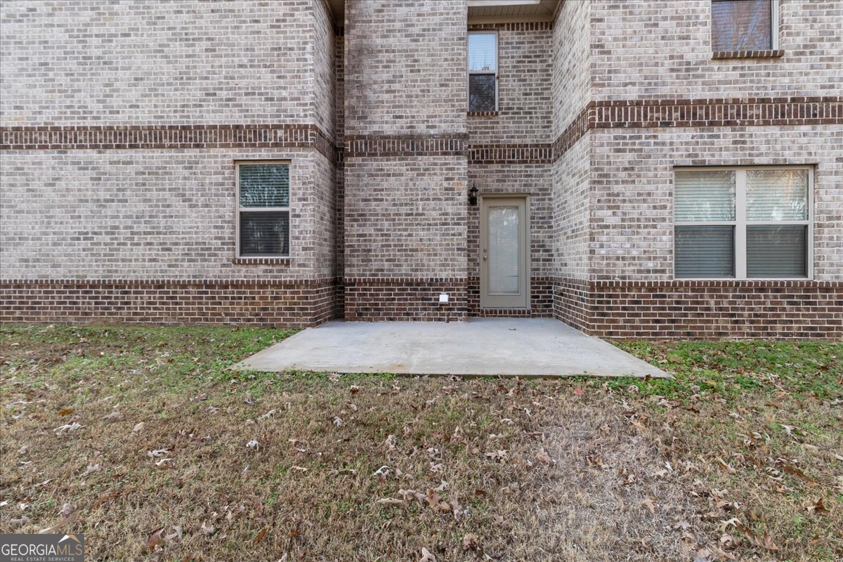 149 Mariahs Walk Hampton, GA 30228 - Photo 44 of 45 a view of a brick house with a yard