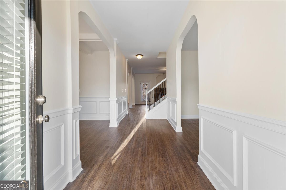 149 Mariahs Walk Hampton, GA 30228 - Photo 7 of 45 a view of a hallway with wooden floor and staircase