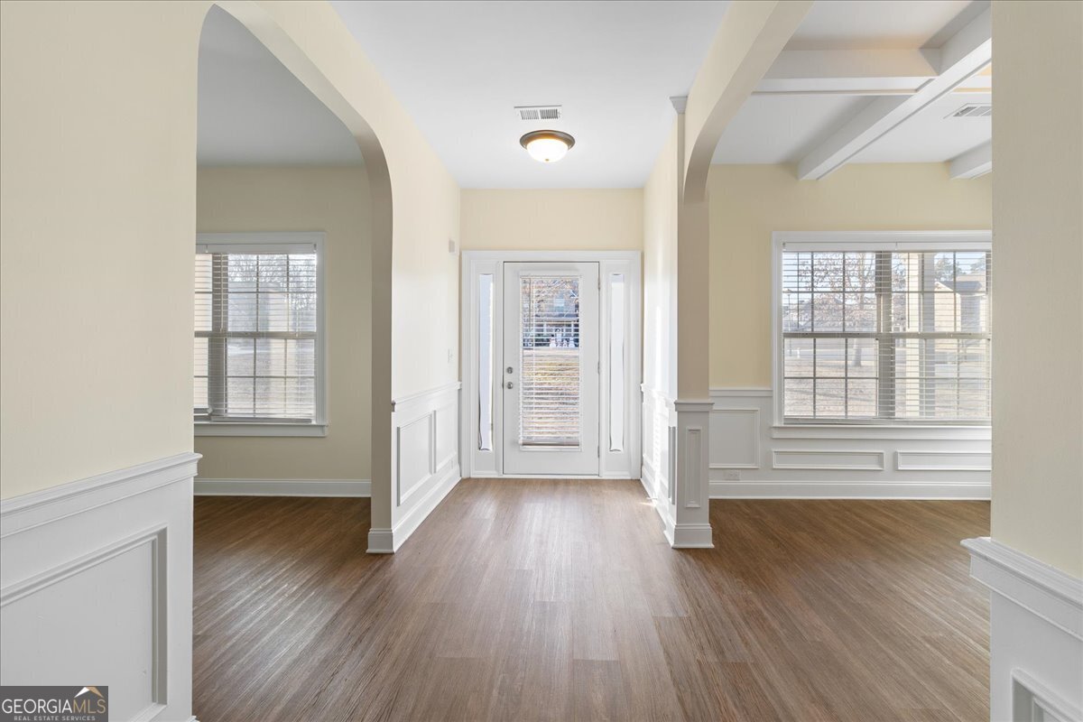 149 Mariahs Walk Hampton, GA 30228 - Photo 8 of 45 a view of an empty room with wooden floor and a window