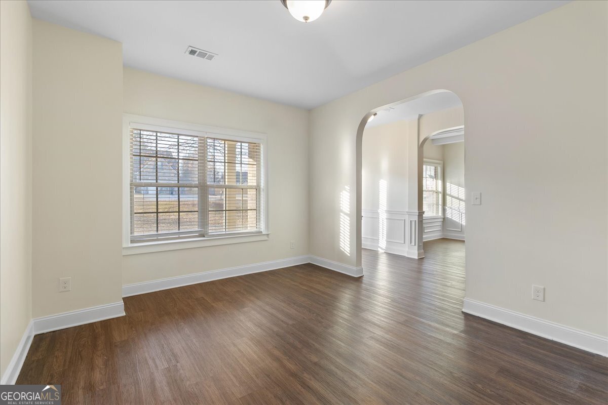 149 Mariahs Walk Hampton, GA 30228 - Photo 9 of 45 an empty room with wooden floor and windows