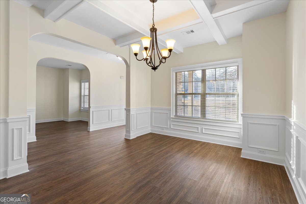 149 Mariahs Walk Hampton, GA 30228 - Photo 10 of 45 a view of an empty room with wooden floor and a window