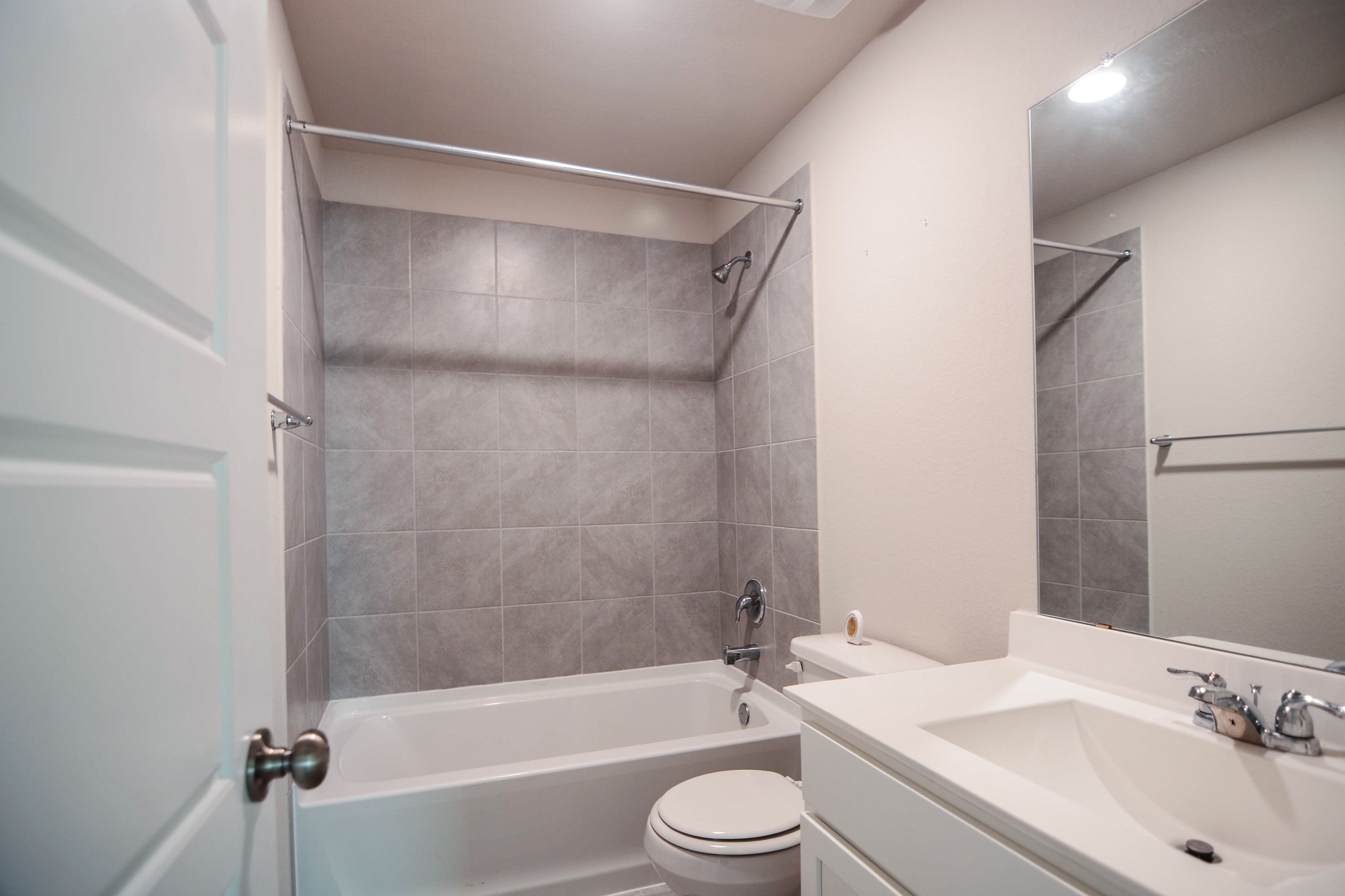 21434 Holly Heights Road Cypress, TX 77433 - Photo 14 of 17 a bathroom with a bathtub shower sink vanity mirror and toilet