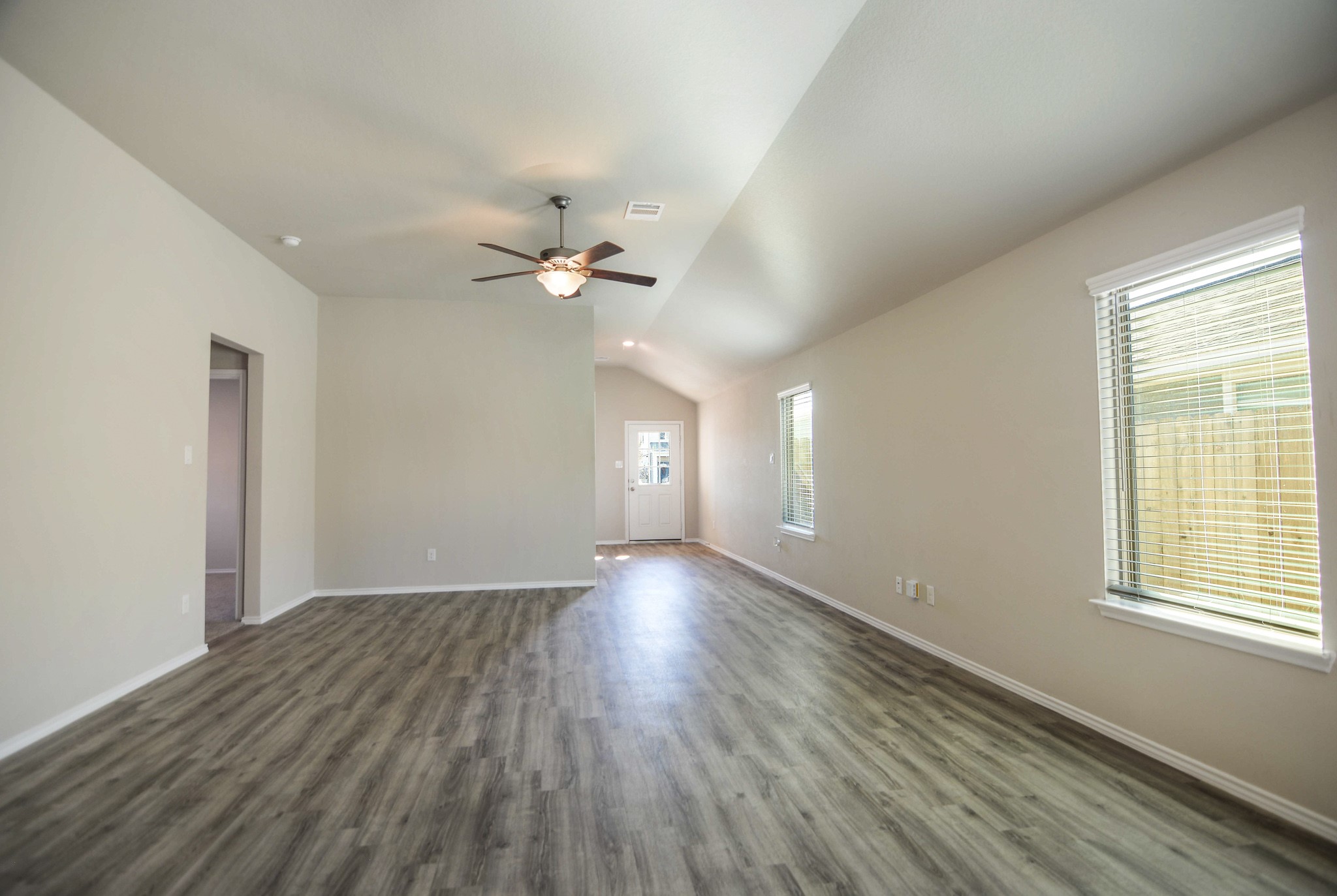 21434 Holly Heights Road Cypress, TX 77433 - Photo 5 of 17 an empty room with wooden floor and windows