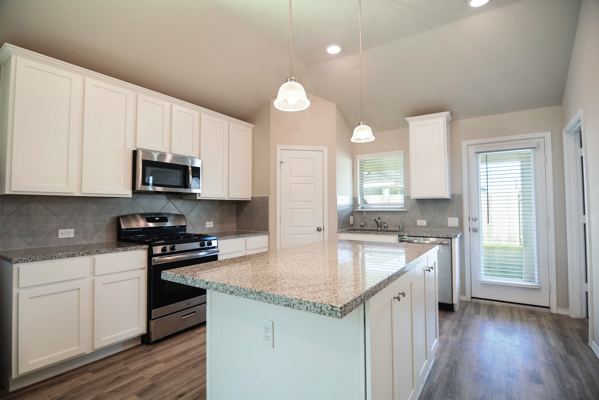 21434 Holly Heights Road Cypress, TX 77433 - Photo 7 of 17 a kitchen with granite countertop a sink cabinets and wooden floor