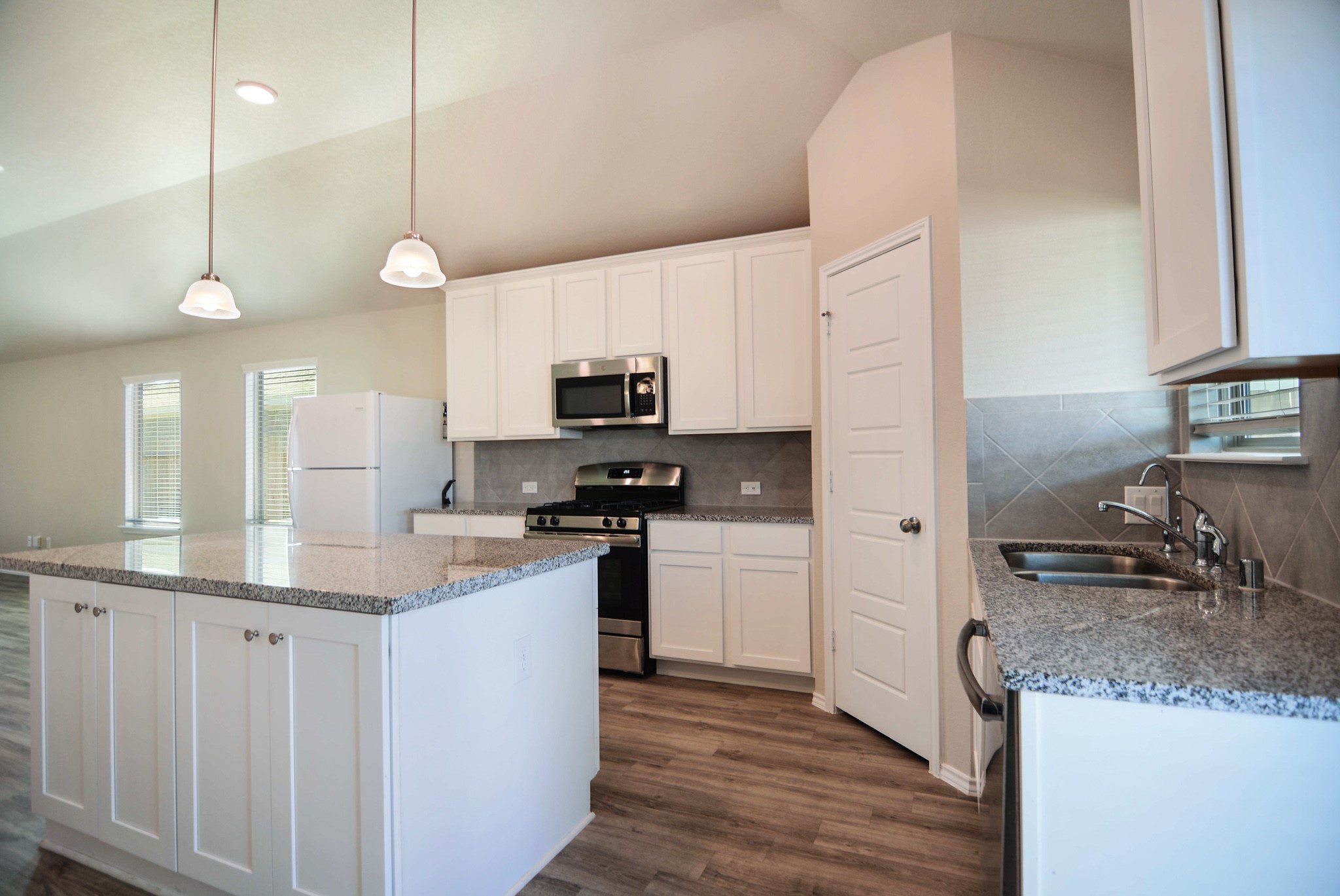 21434 Holly Heights Road Cypress, TX 77433 - Photo 8 of 17 a kitchen with stainless steel appliances granite countertop a sink a stove and a refrigerator