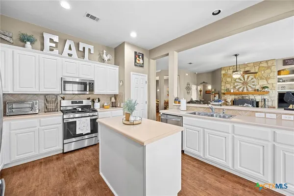 a view of workspace with wooden floor and windows