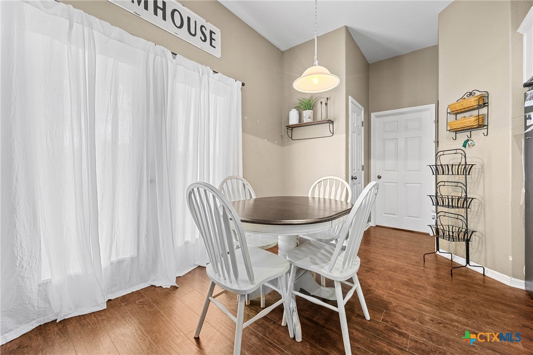 350 Lehne Road Bertram, TX 78605 - Photo 15 of 33 a dining room with furniture and wooden floor