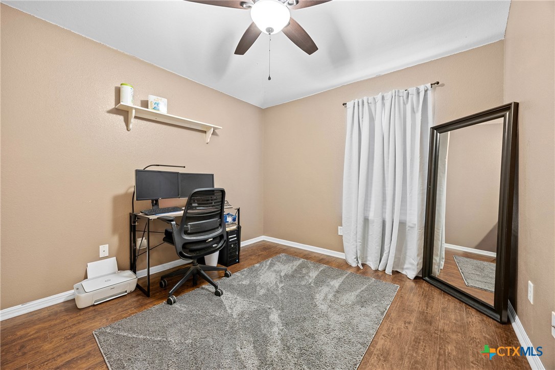 350 Lehne Road Bertram, TX 78605 - Photo 19 of 33 a view of workspace with wooden floor and windows