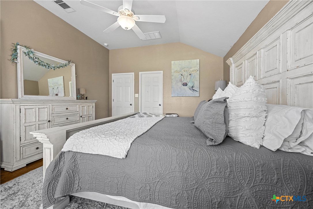 350 Lehne Road Bertram, TX 78605 - Photo 22 of 33 a bedroom with a bed and a chandelier
