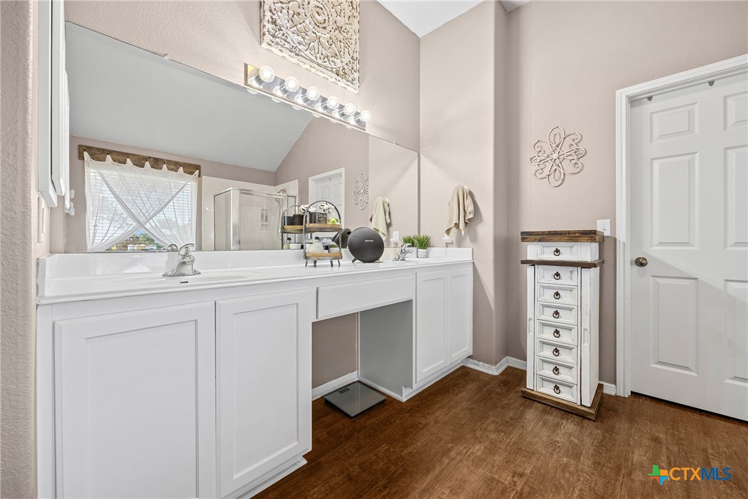 350 Lehne Road Bertram, TX 78605 - Photo 23 of 33 a bathroom with a double vanity sink a mirror and shower
