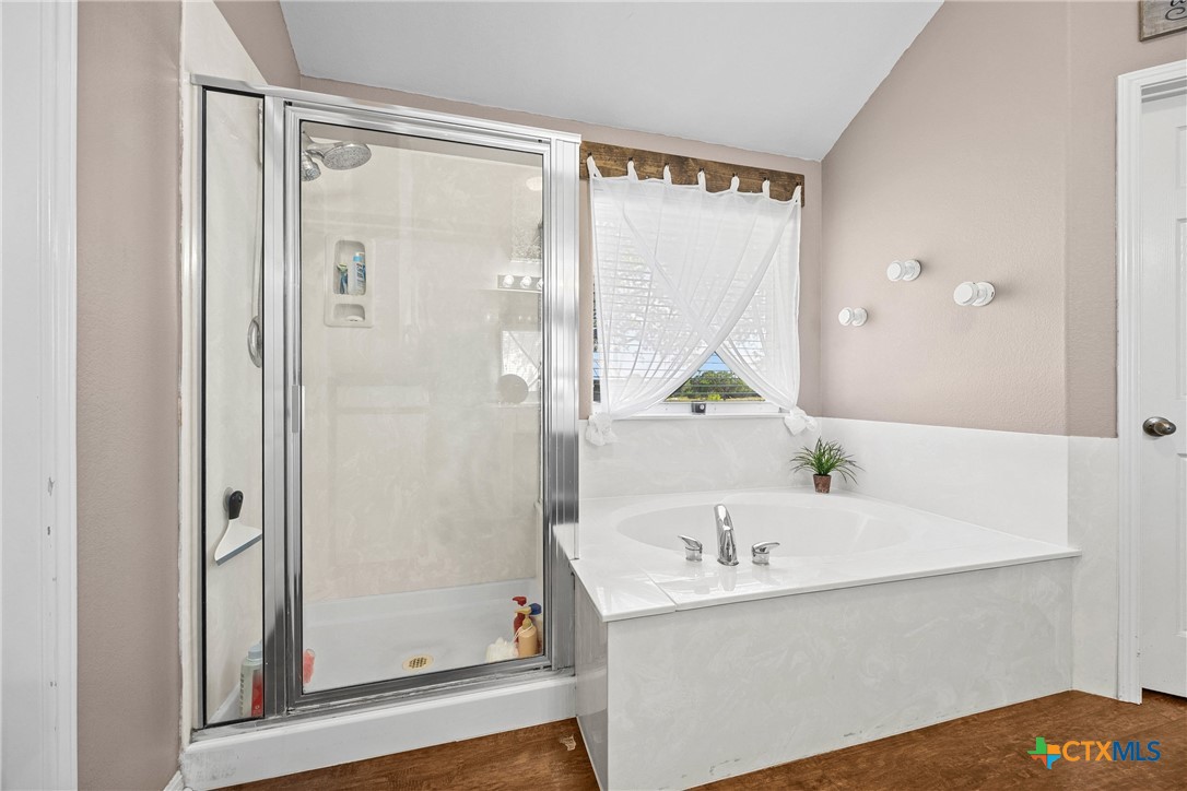 350 Lehne Road Bertram, TX 78605 - Photo 25 of 33 a bathroom with a bathtub and a shower