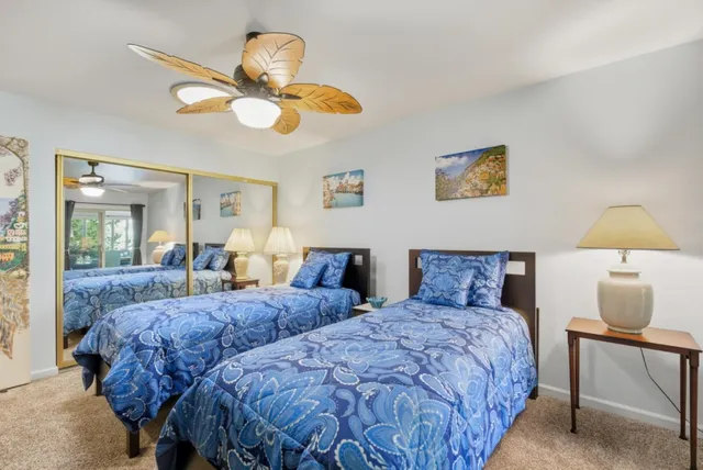 a bedroom with two beds and a window