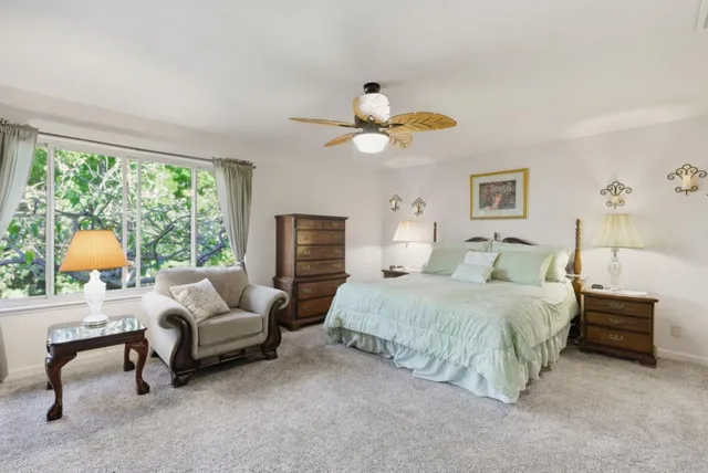 a spacious bedroom with a bed and a chandelier
