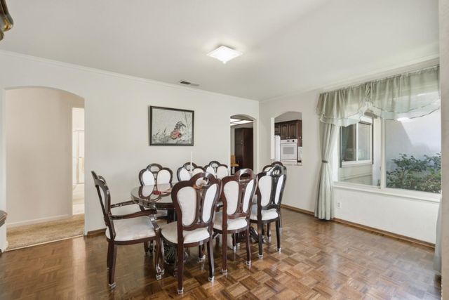 a view of a dining room with furniture and wooden floor