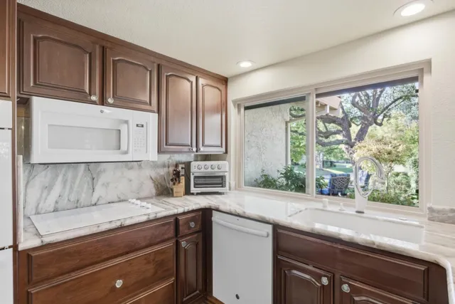 a kitchen with granite countertop a sink and a window