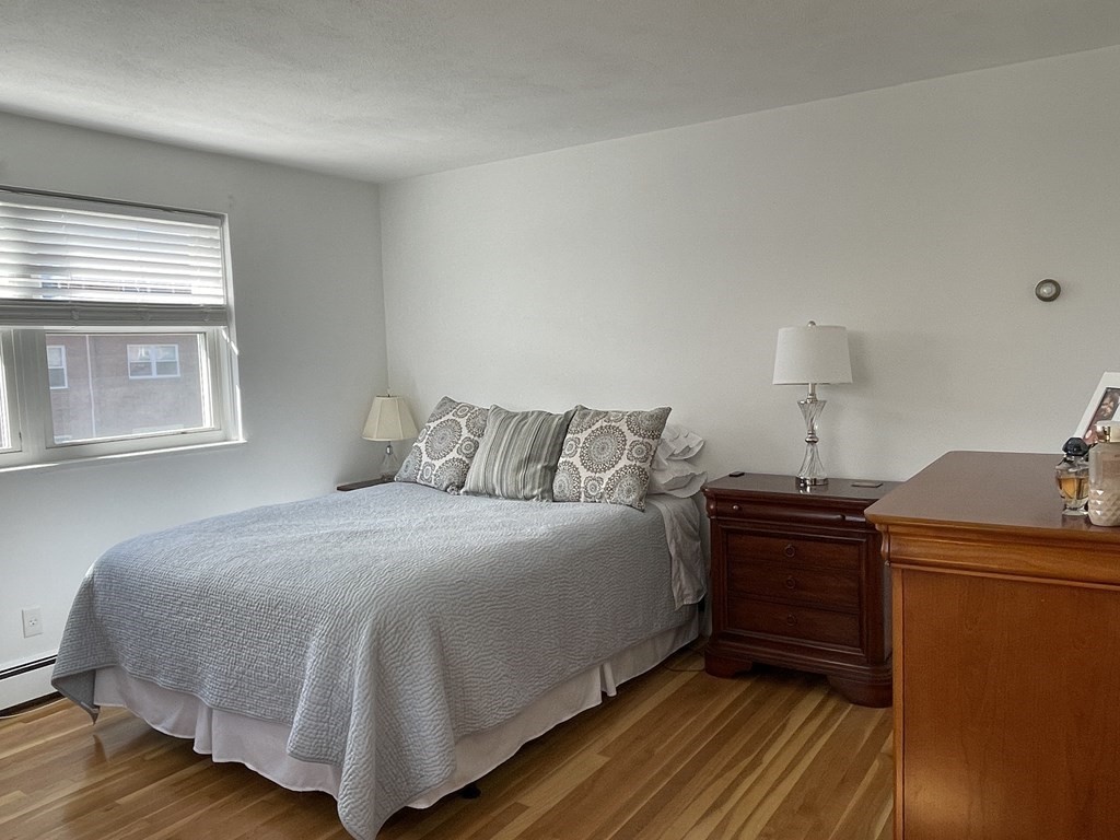 32 Whitman Road, Unit 12 Waltham, MA 02453 - Photo 12 of 19 a bedroom with a bed and a window