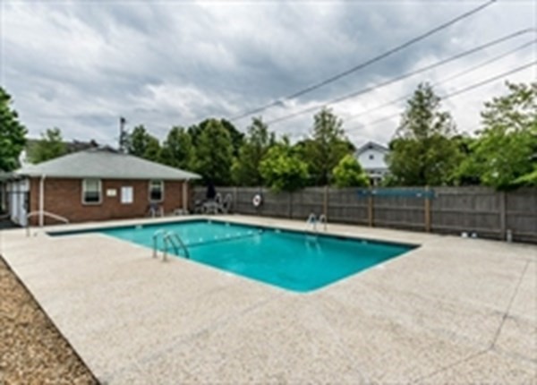 32 Whitman Road, Unit 12 Waltham, MA 02453 - Photo 19 of 19 a view of swimming pool with a yard in front of it
