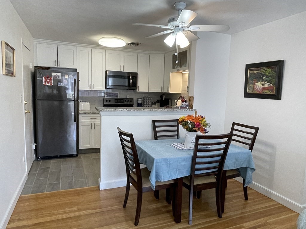 32 Whitman Road, Unit 12 Waltham, MA 02453 - Photo 5 of 19 a view of a dining room with furniture and wooden floor