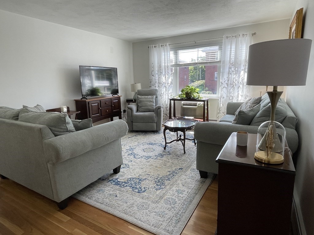 32 Whitman Road, Unit 12 Waltham, MA 02453 - Photo 6 of 19 a living room with furniture and a lamp
