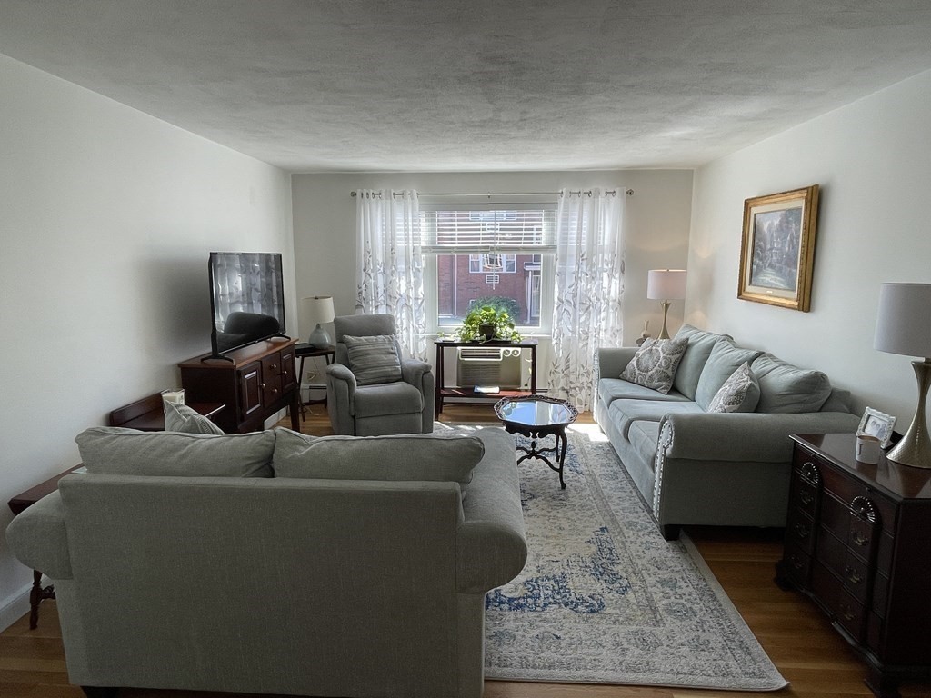 32 Whitman Road, Unit 12 Waltham, MA 02453 - Photo 10 of 19 a living room with furniture and a rug