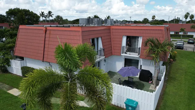 a view of a house with wooden fence