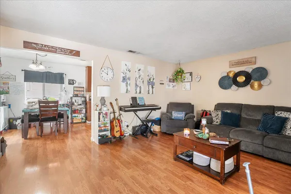 a living room with furniture and wooden floor