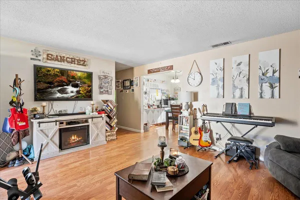a view of a livingroom with furniture a flat screen tv and couches