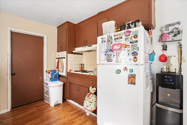 a white refrigerator freezer sitting inside of a kitchen