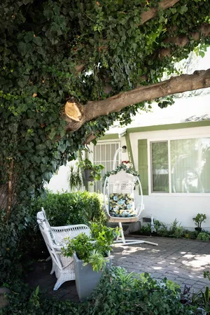 a front view of a house with a yard garage and outdoor seating