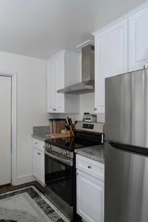 a kitchen with a stove and a refrigerator