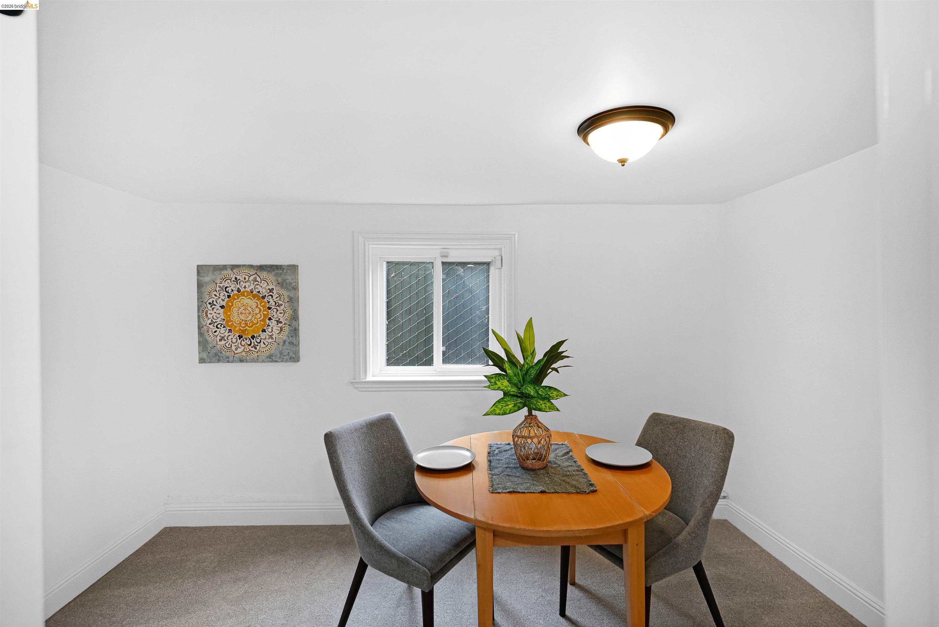 1812 Woolsey Street Berkeley, CA 94703 - Photo 39 of 48 Compact dining area featuring a double-hung window, wall-to-wall carpeting, and a semi-flush mount ceiling light
