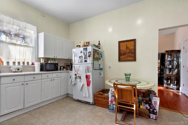 a kitchen with a stove a sink a table and chairs