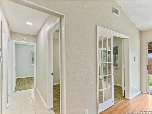 a view of a bedroom with wooden floor and bathroom