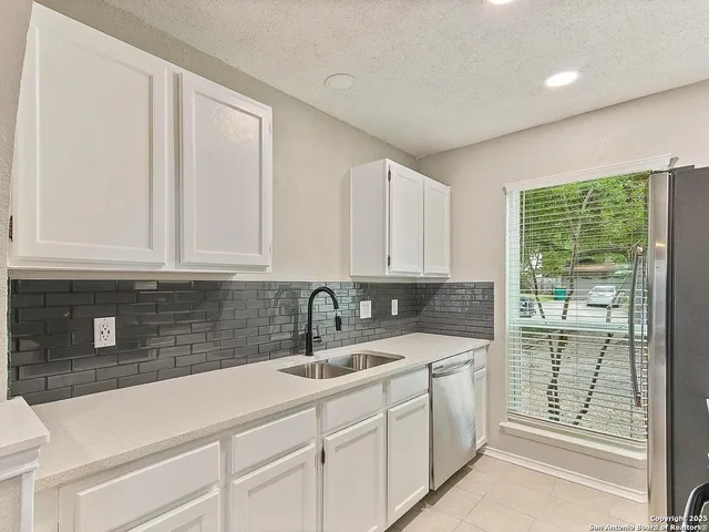 a kitchen with appliances cabinets and a sink