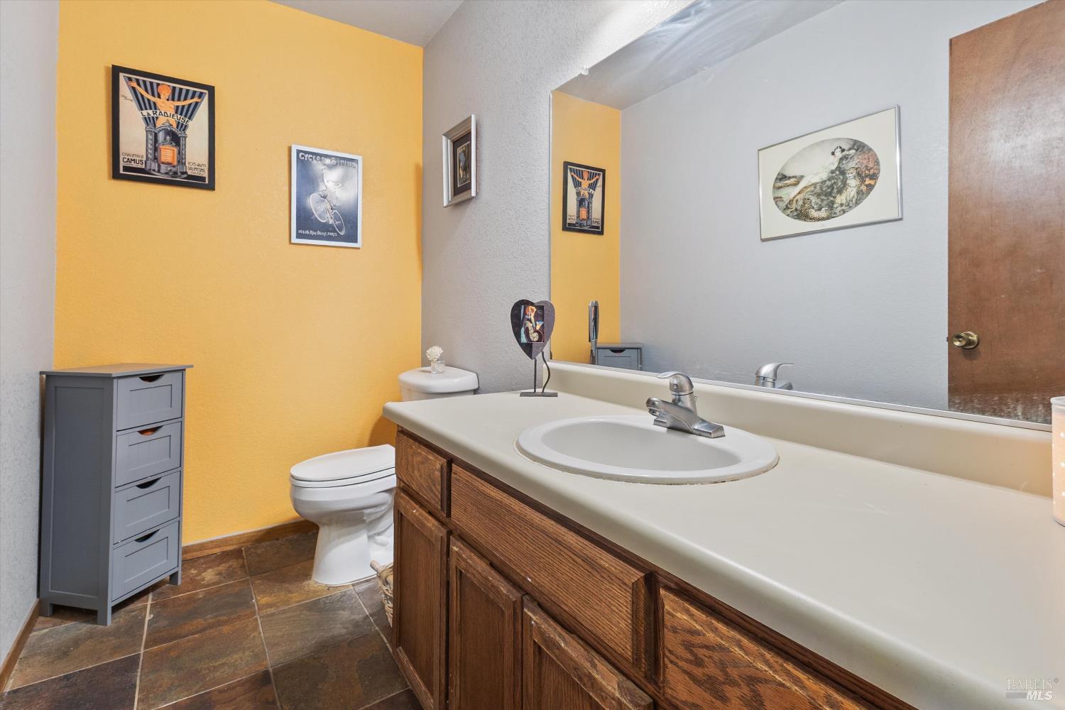 101 Pinewood Court Cotati, CA 94931 - Photo 12 of 21 a bathroom with a granite countertop sink and a toilet