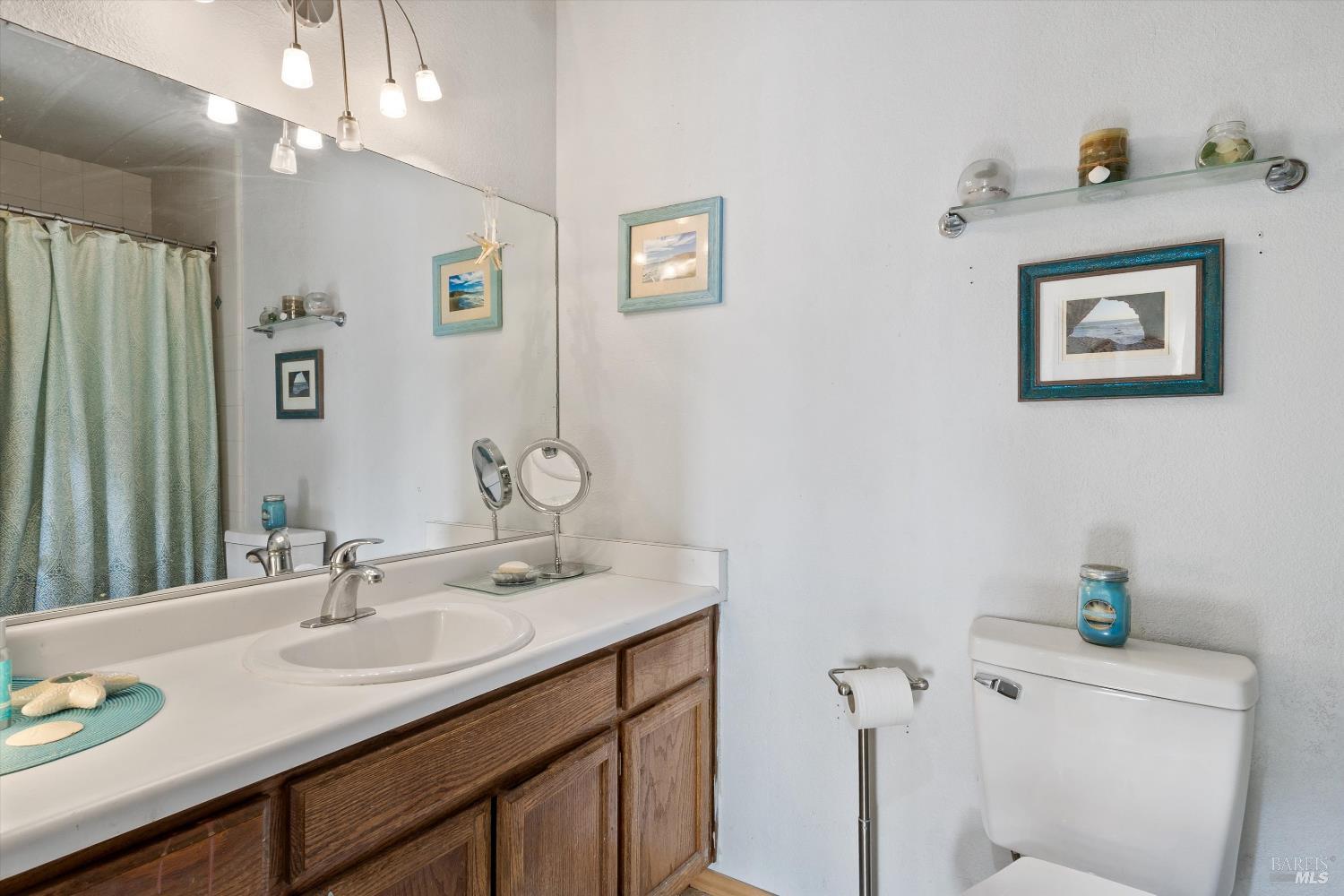 101 Pinewood Court Cotati, CA 94931 - Photo 17 of 21 a bathroom with a toilet sink and mirror