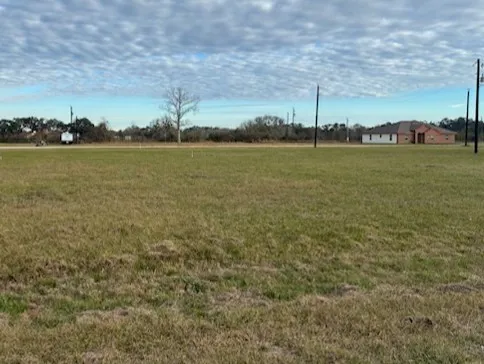 a view of a field with an ocean view
