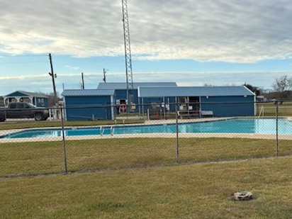 Tbd Riverside Drive Palacios, TX 77465 - Photo 4 of 4 a view of a swimming pool with a lawn chairs