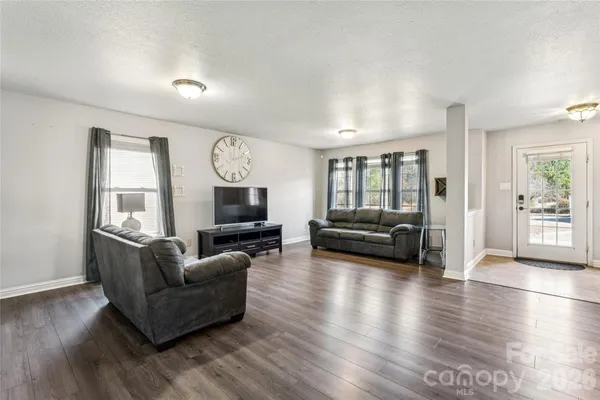 a living room with furniture window and wooden floor