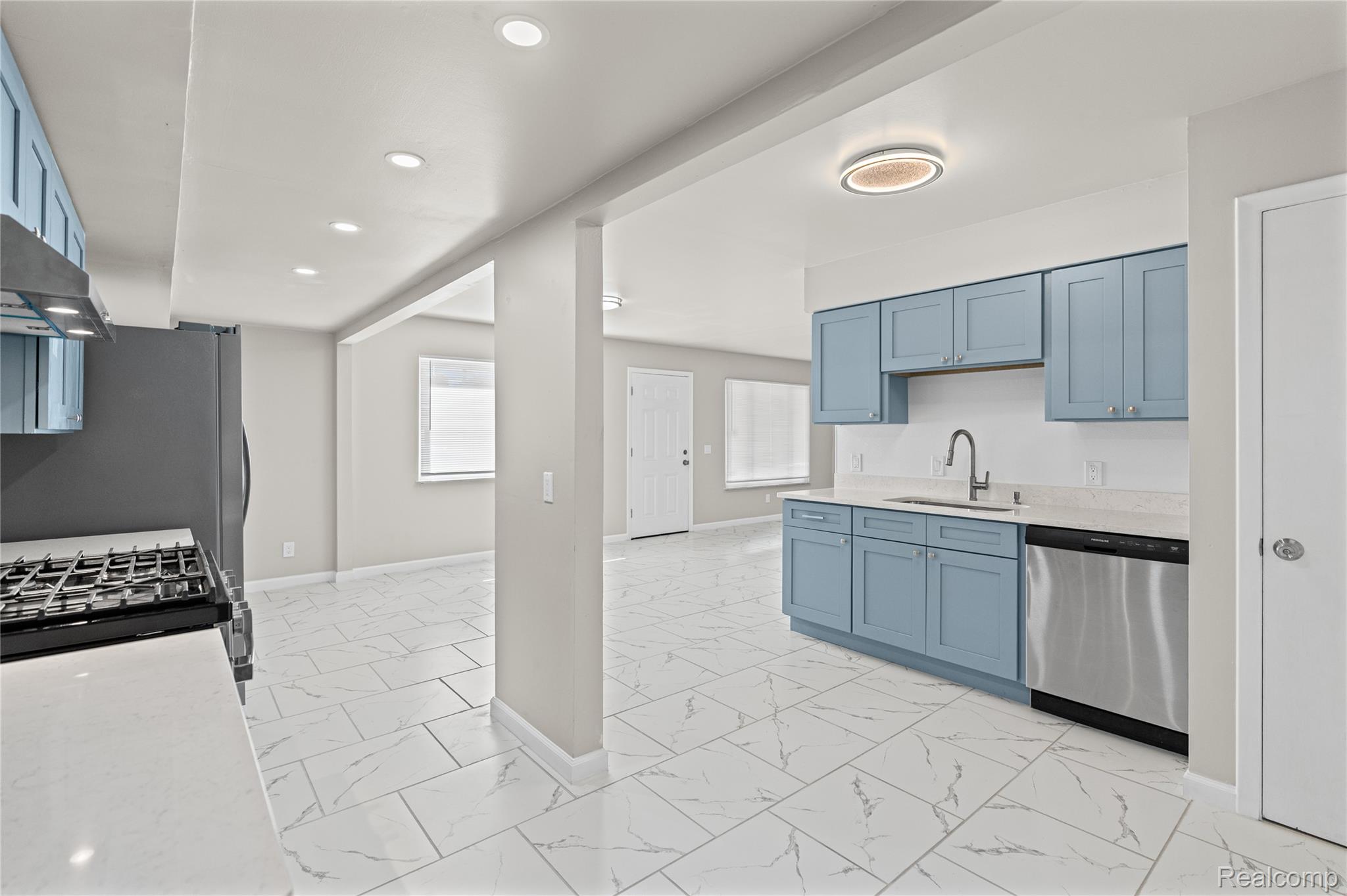 3710 Branch Road Flint, MI 48506 - Photo 17 of 46 Kitchen featuring light blue cabinetry, white countertops, tile flooring with grey veining, stainless steel appliances, and recessed lighting