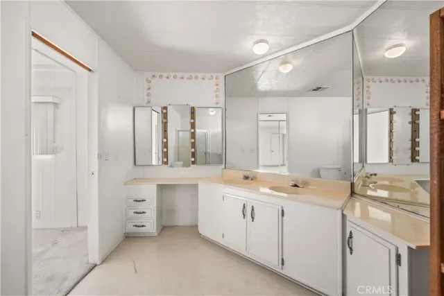 a bathroom with a double vanity sink mirror and double