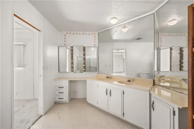 a bathroom with a double vanity sink mirror and double