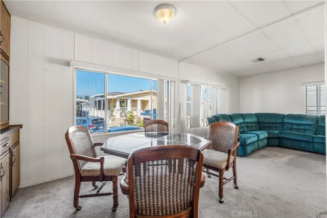 a dining room with furniture and window