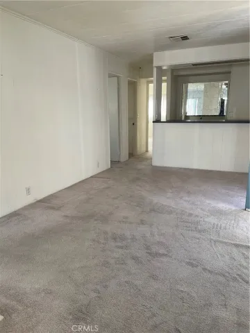 a utility room with stainless steel appliances cabinets a sink and a window