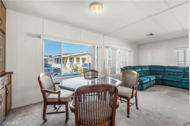 a dining room with furniture and window