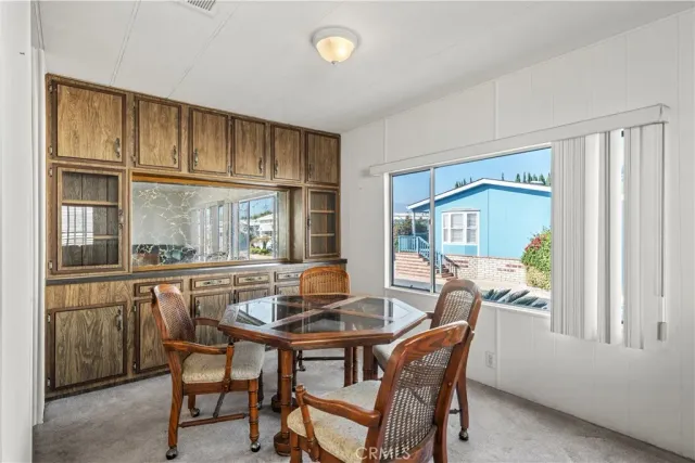 a dining room with furniture window and outside view